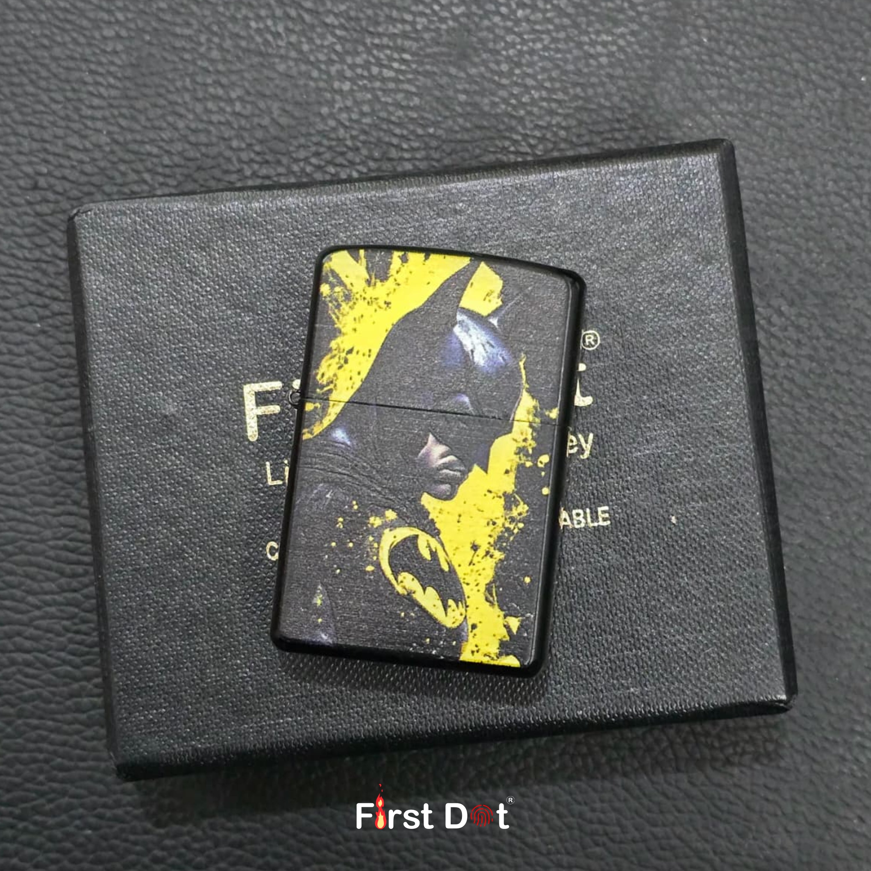 Black and yellow lighter on a black box with 'First Dot' branding.