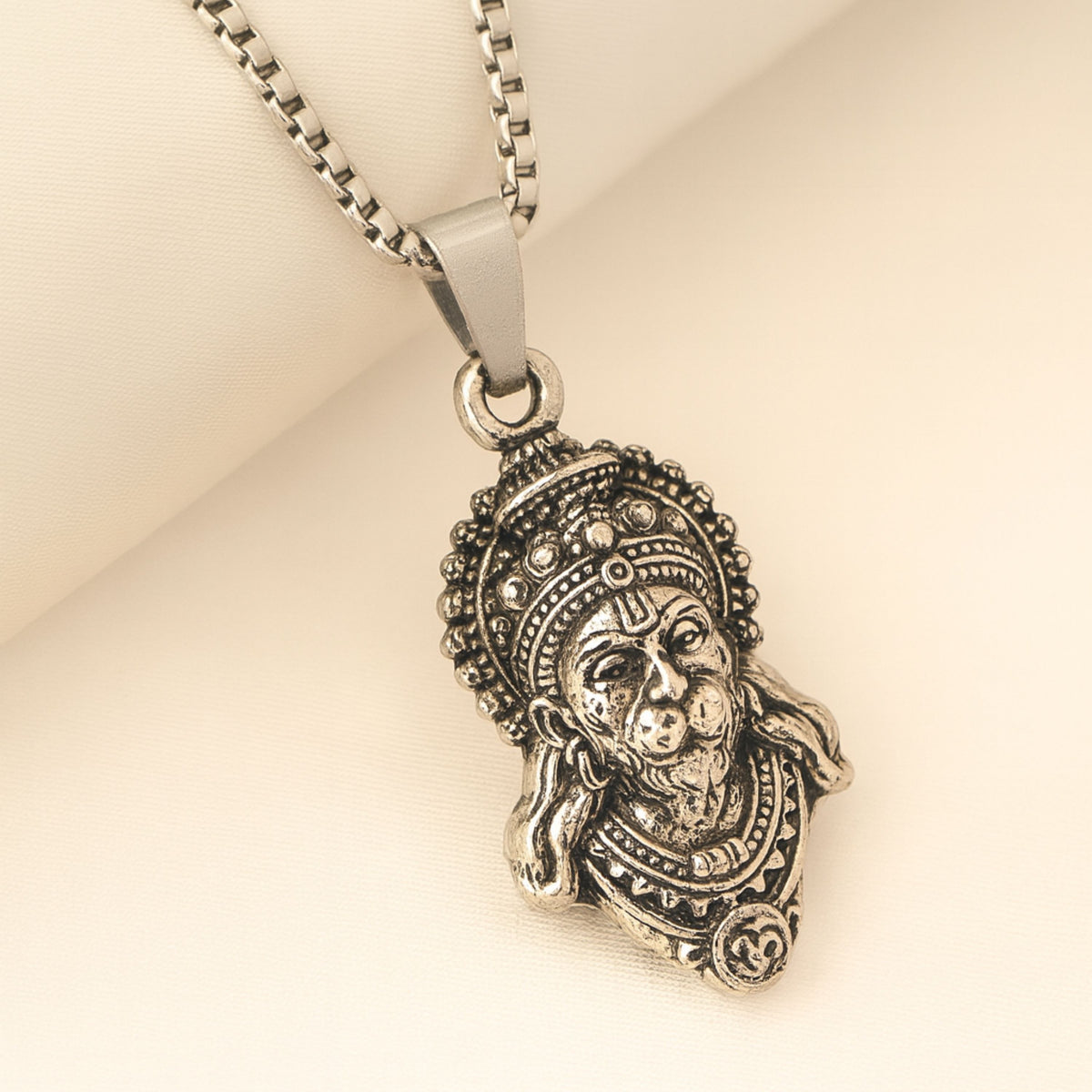 Silver pendant necklace with intricate design on a beige background HanumanjiPendantL