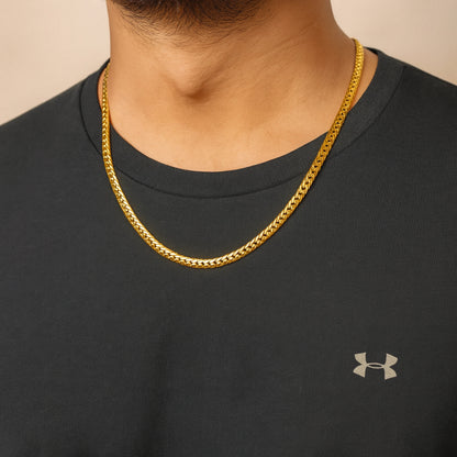 Person wearing a gold chain necklace with a black Under Armour shirt. First Dot Italian Golden Curb Chain for Men