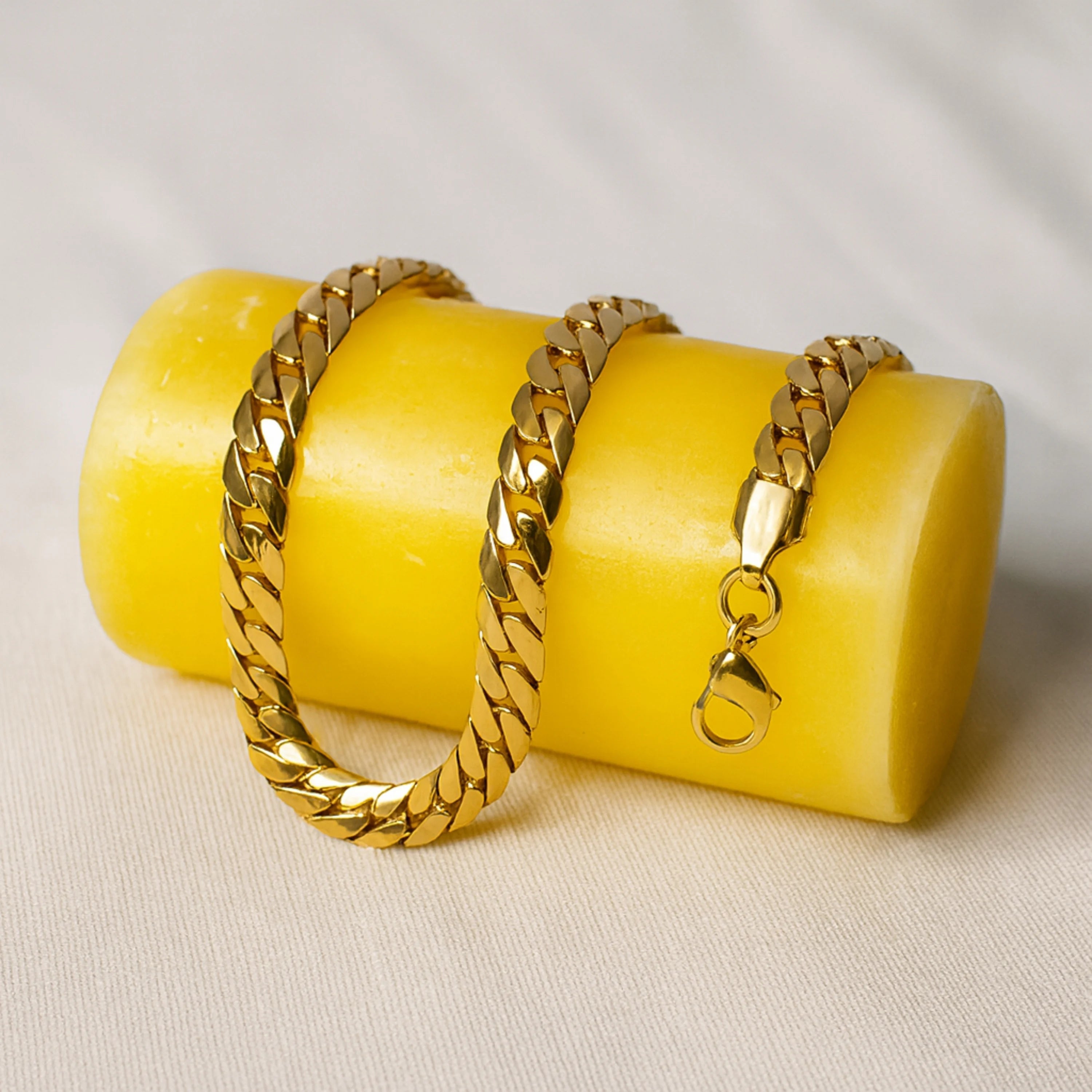 Gold chain on a yellow block with a white background First Dot Italian Golden Curb Chain for Men