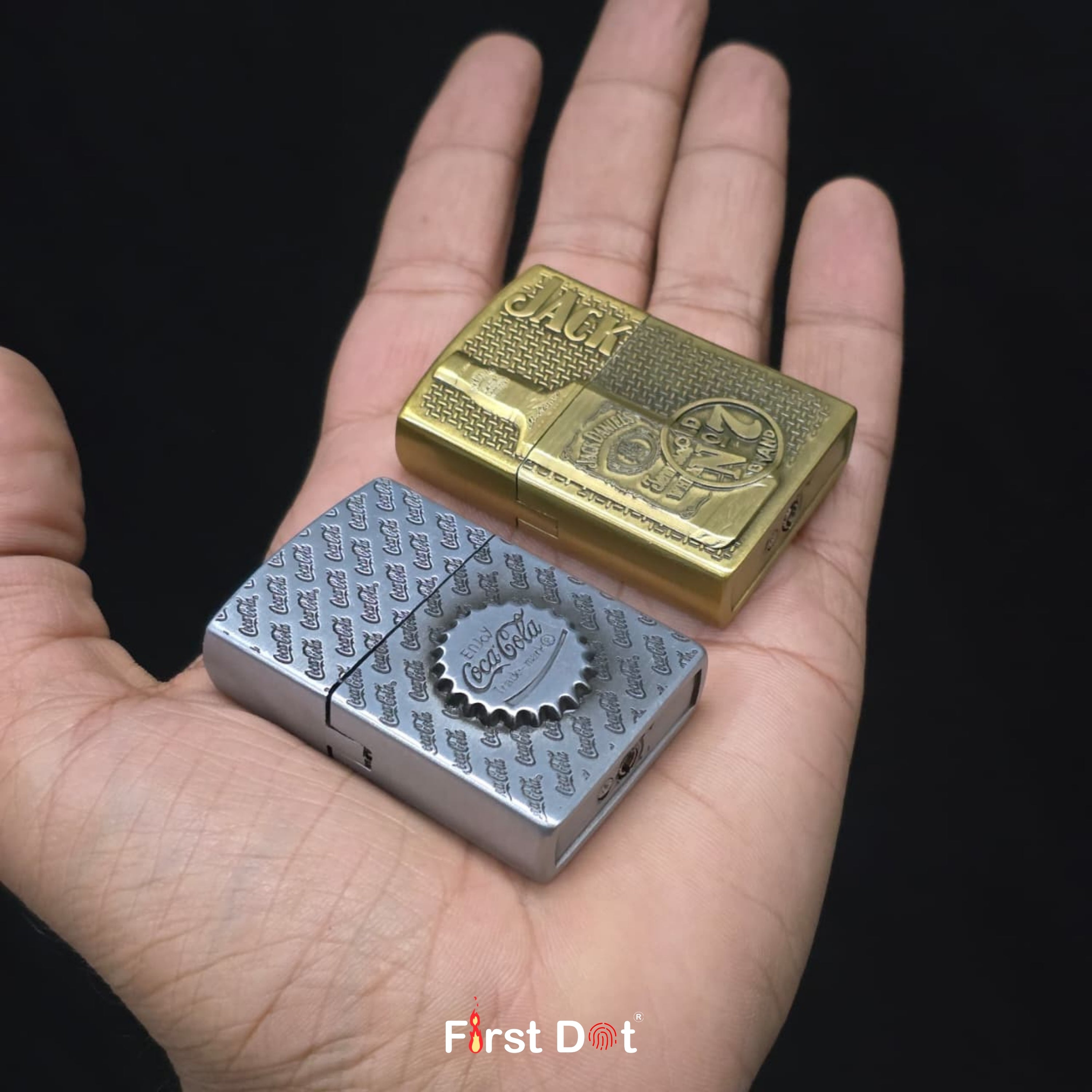 Two lighters, one gold and one silver, held in a hand with a black background.