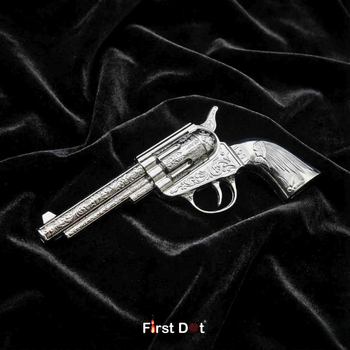 Silver revolver-shaped object on black velvet fabric with 'First Dot' branding. Mini Antique Revolver Gun Lighter – Jet Flame Windproof | First Dot