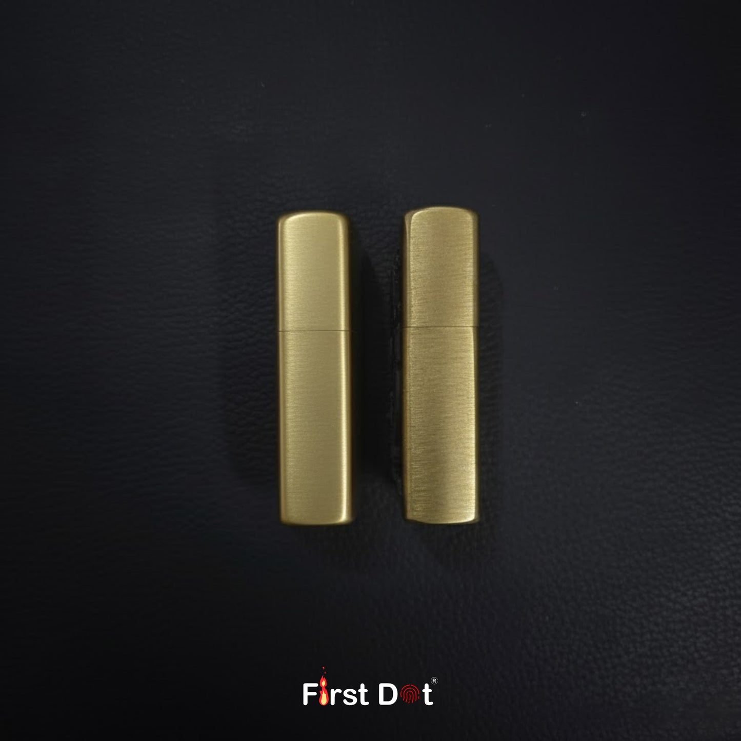 Two gold lighters on a black textured background with 'First Dot' branding.