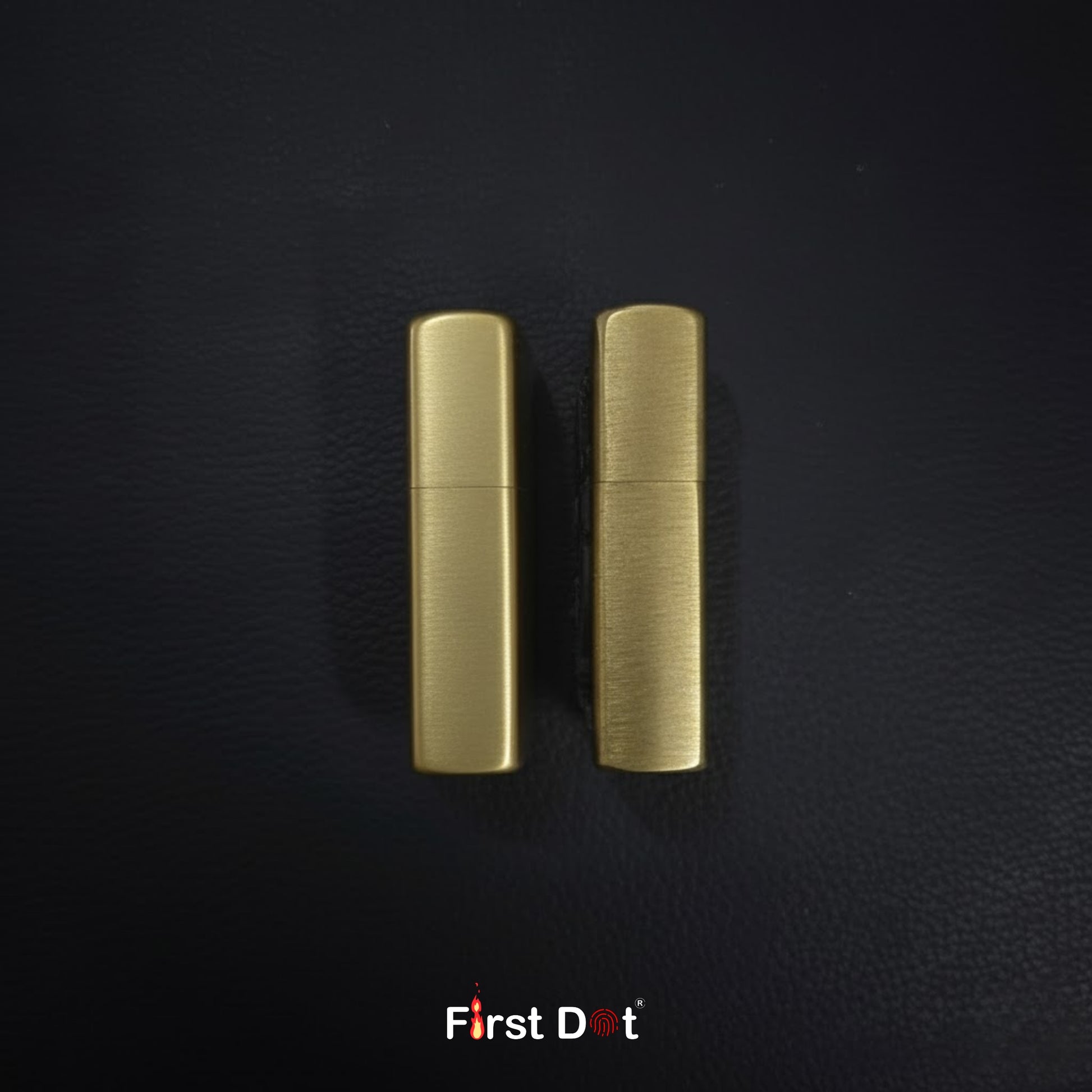 Two gold lighters on a black textured background with 'First Dot' branding.