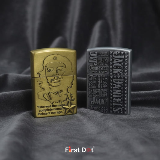 Two lighters, one gold and one gray, on a dark fabric background with 'First Dot' branding.