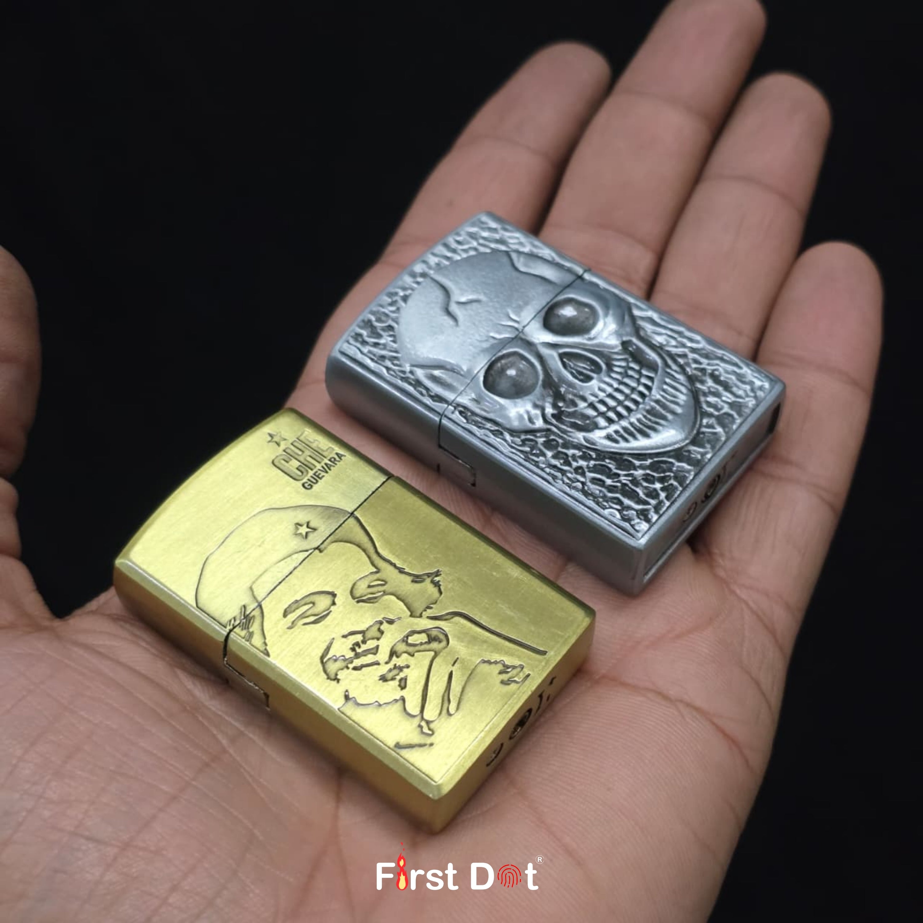 Two zippo lighters, one gold and one silver with skull design, held in a hand against a black background.