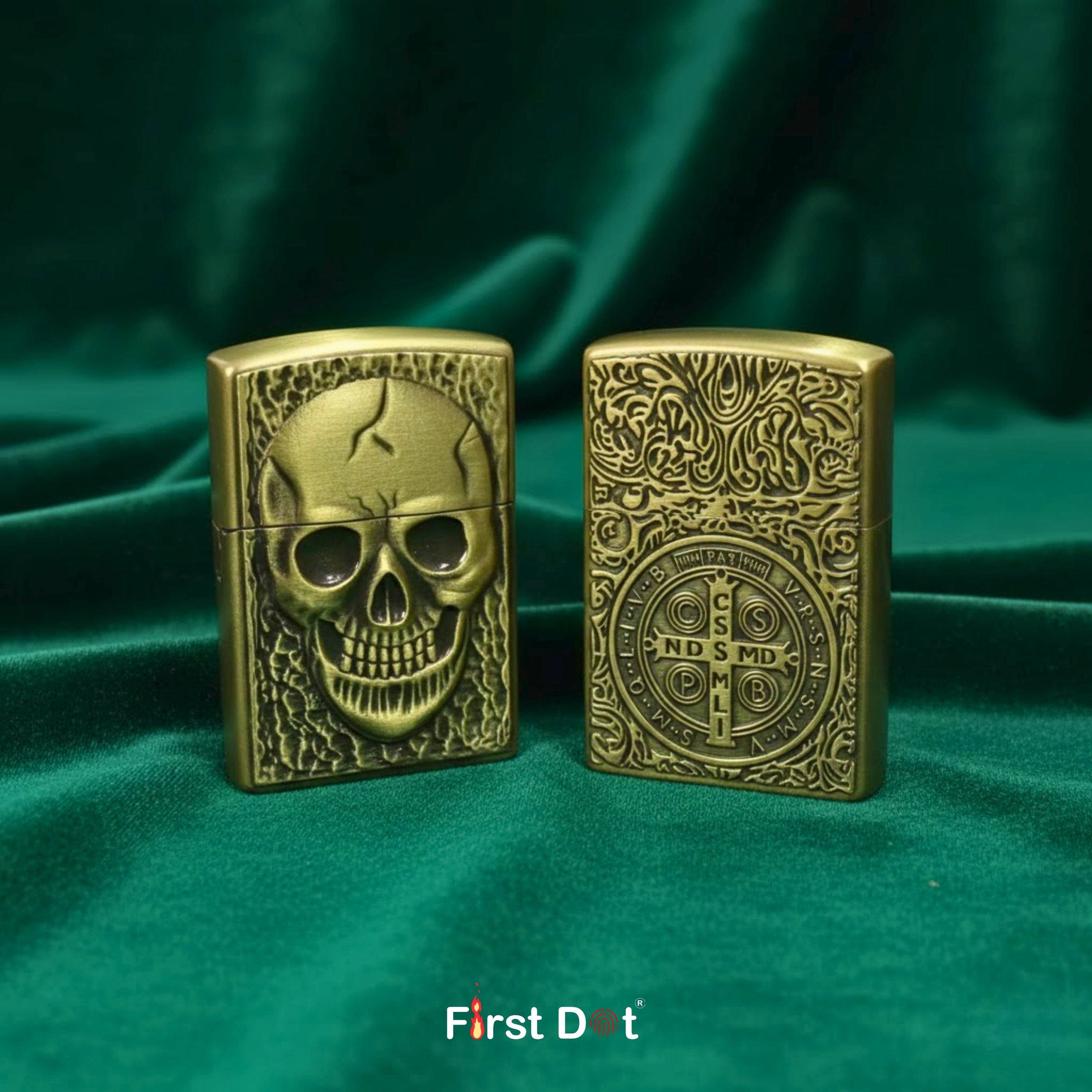 Two ornate brass lighters on a green fabric background with 'First Dot' branding.