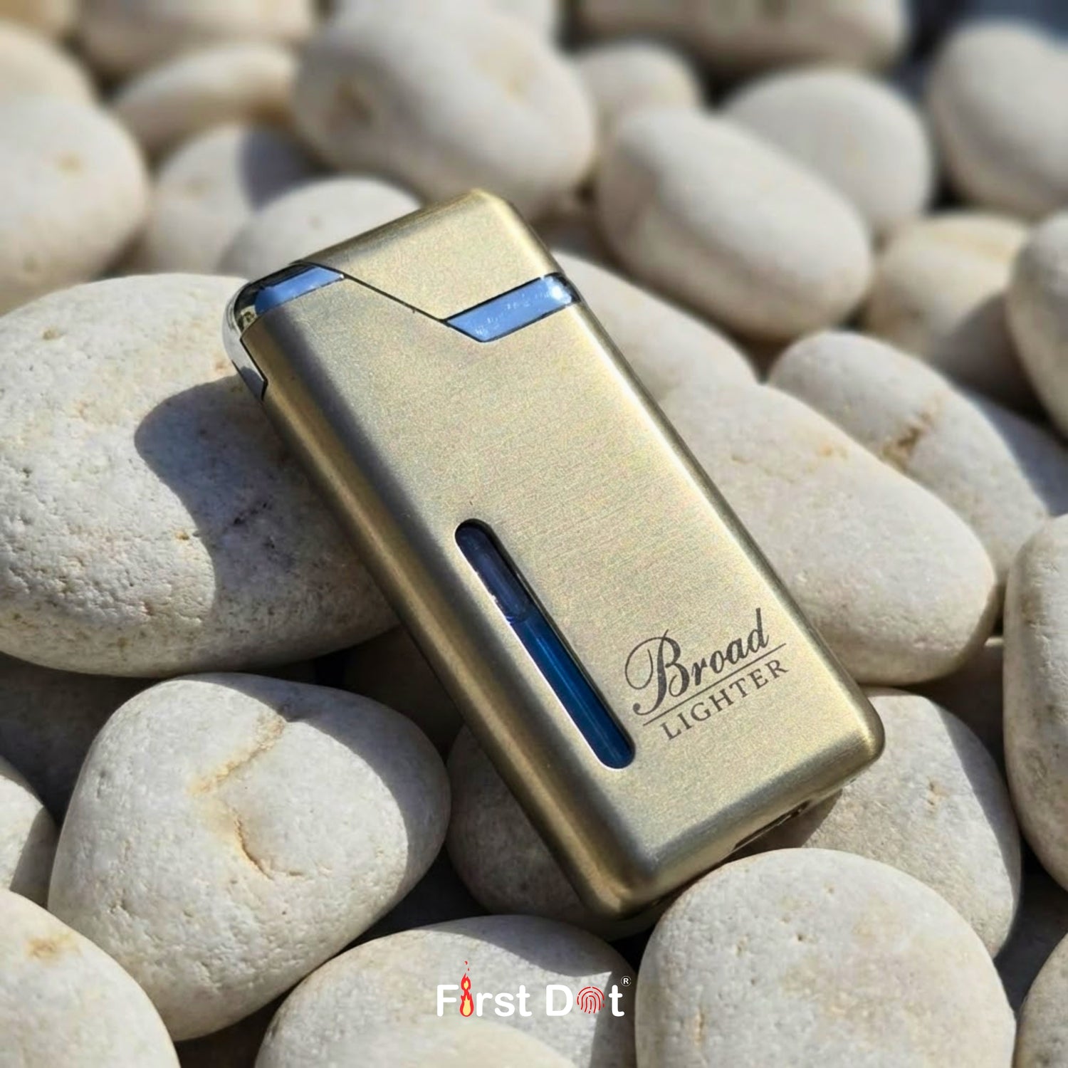 Gold lighter with blue accents on pebbles, branded 'First Dot'.