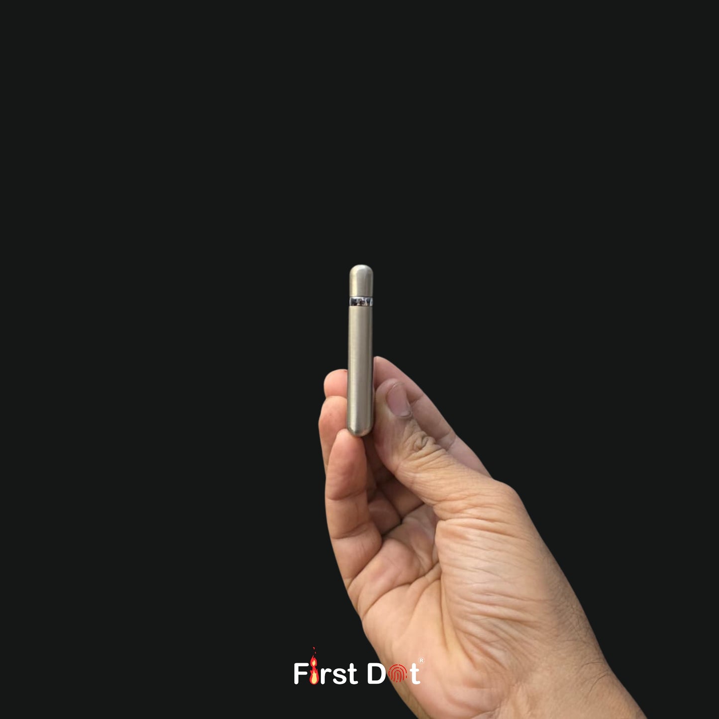 Hand holding a small electronic device against a black background with 'First Dot' branding.