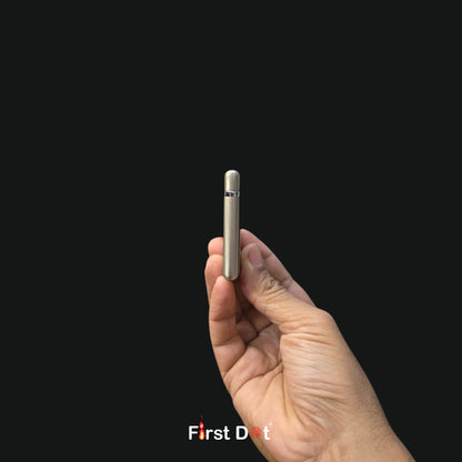 Hand holding a small electronic device against a black background with 'First Dot' branding.