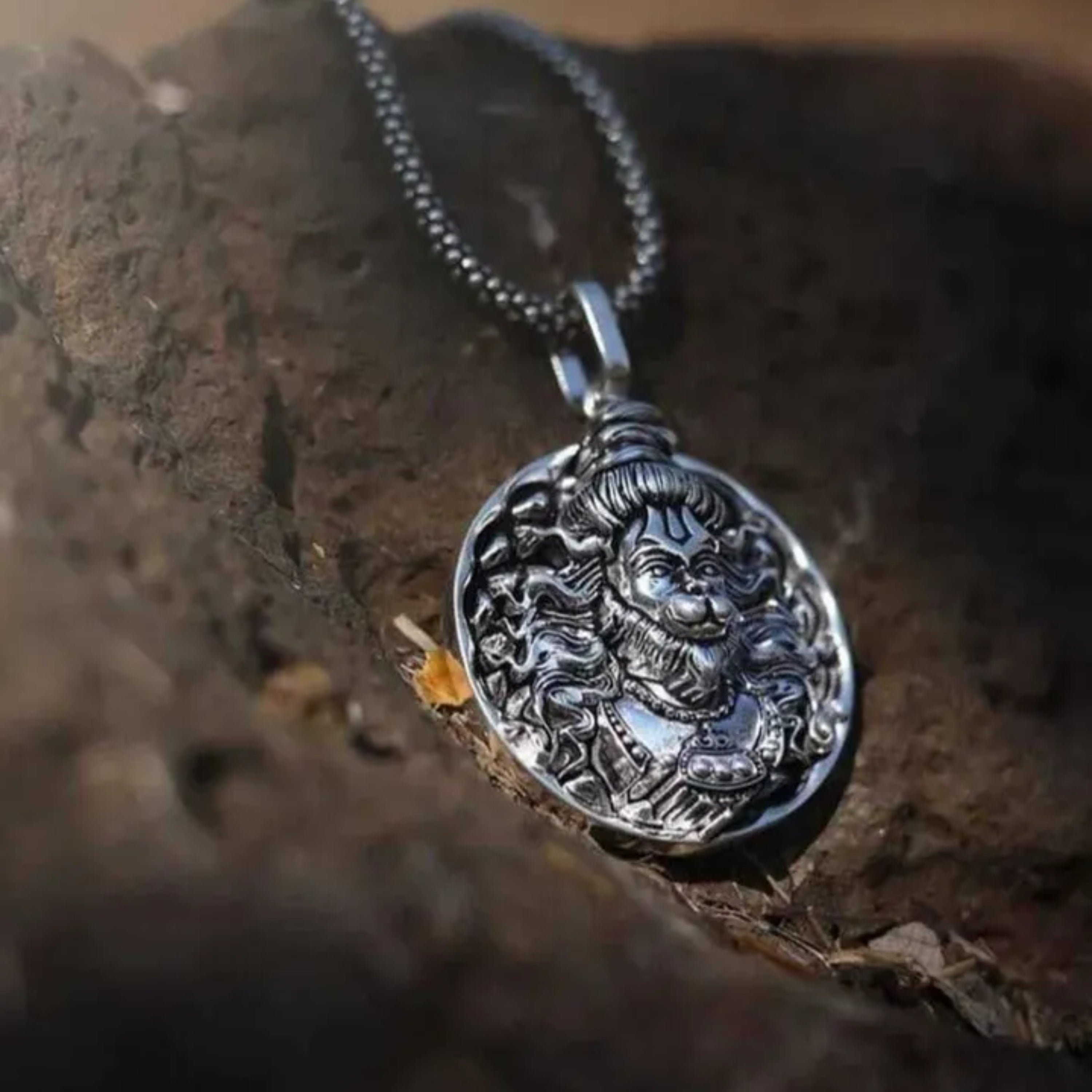 Silver pendant with intricate design on a wooden surface श्री हनुमान जी Round Pendant Locket with Chain 