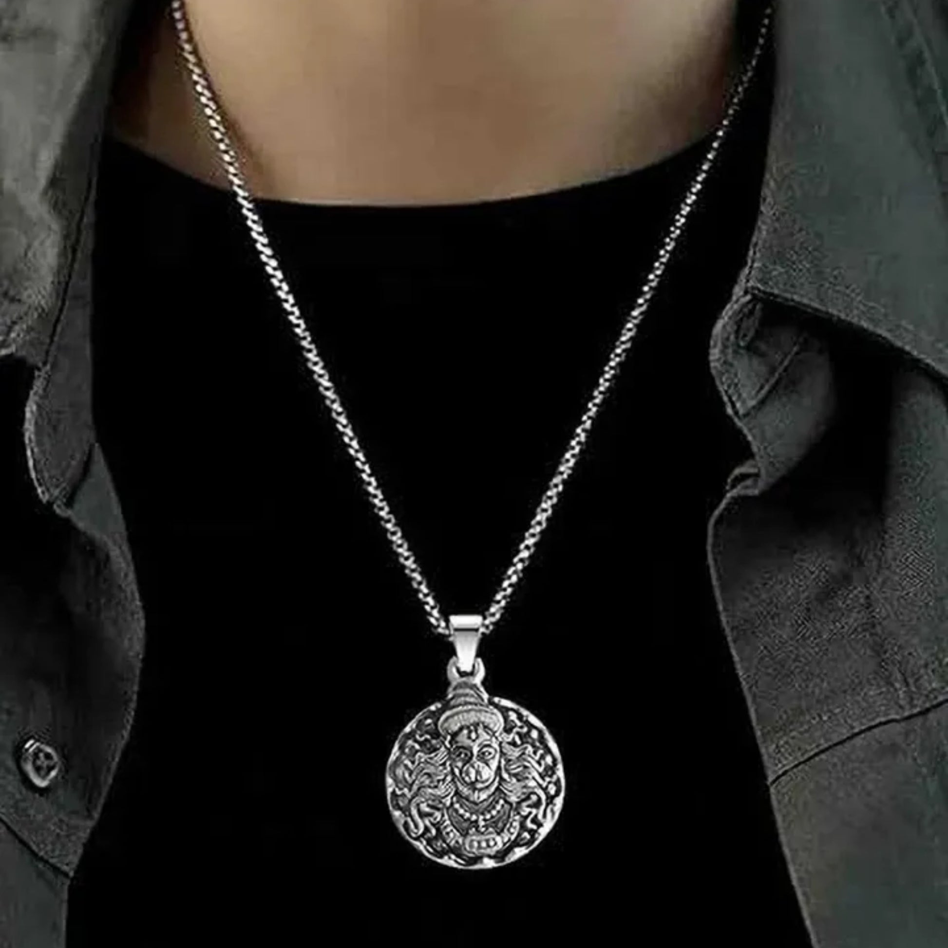 Silver necklace with a detailed pendant worn by a person against a black background श्री हनुमान जी Round Pendant Locket with Chain 