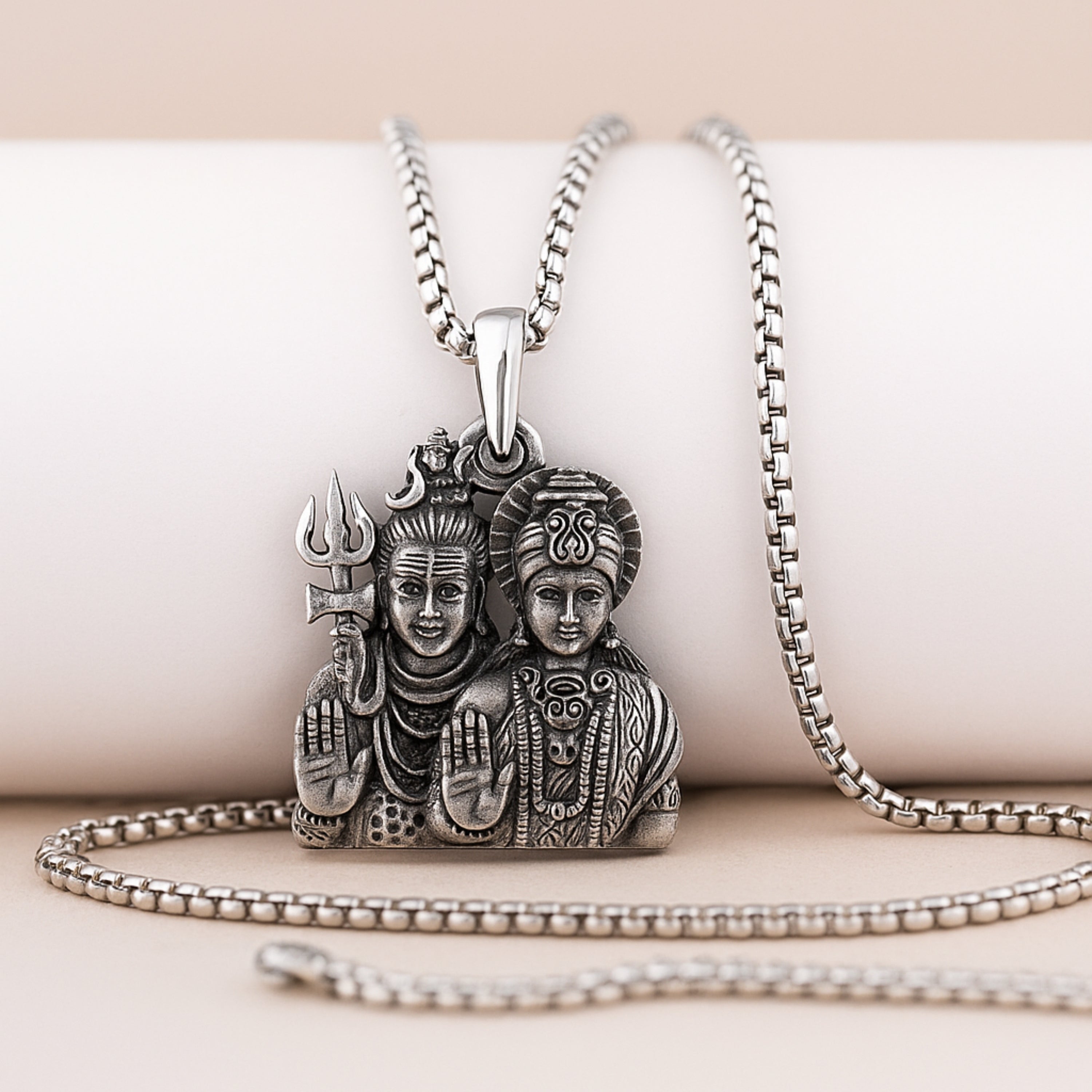 Silver pendant necklace with intricate design on a beige background ShivaParvatiLocketwithChain