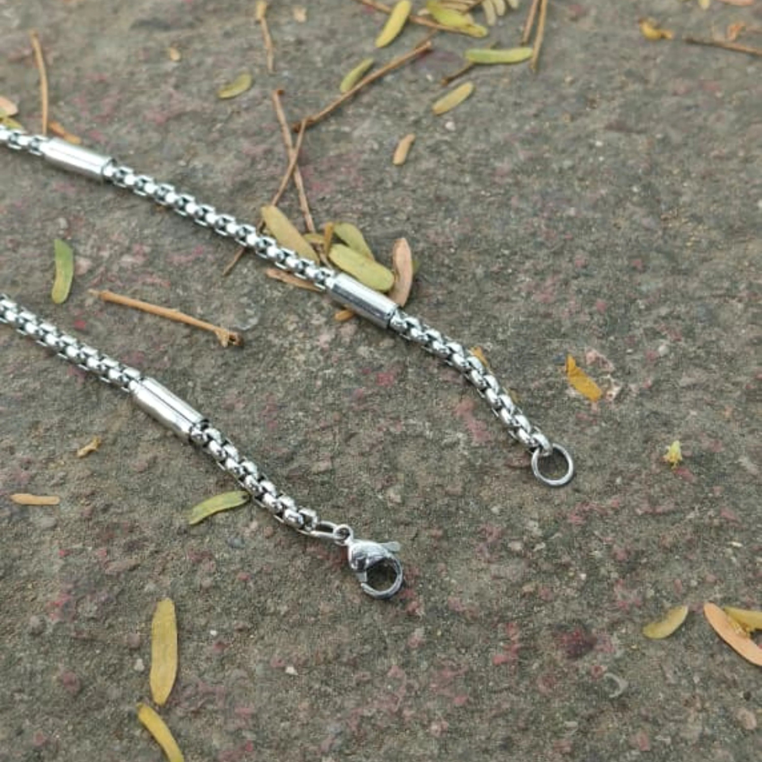 Silver chain bracelet on a textured surface with leaves First Dot Silver Ball Beaded Chain for Men