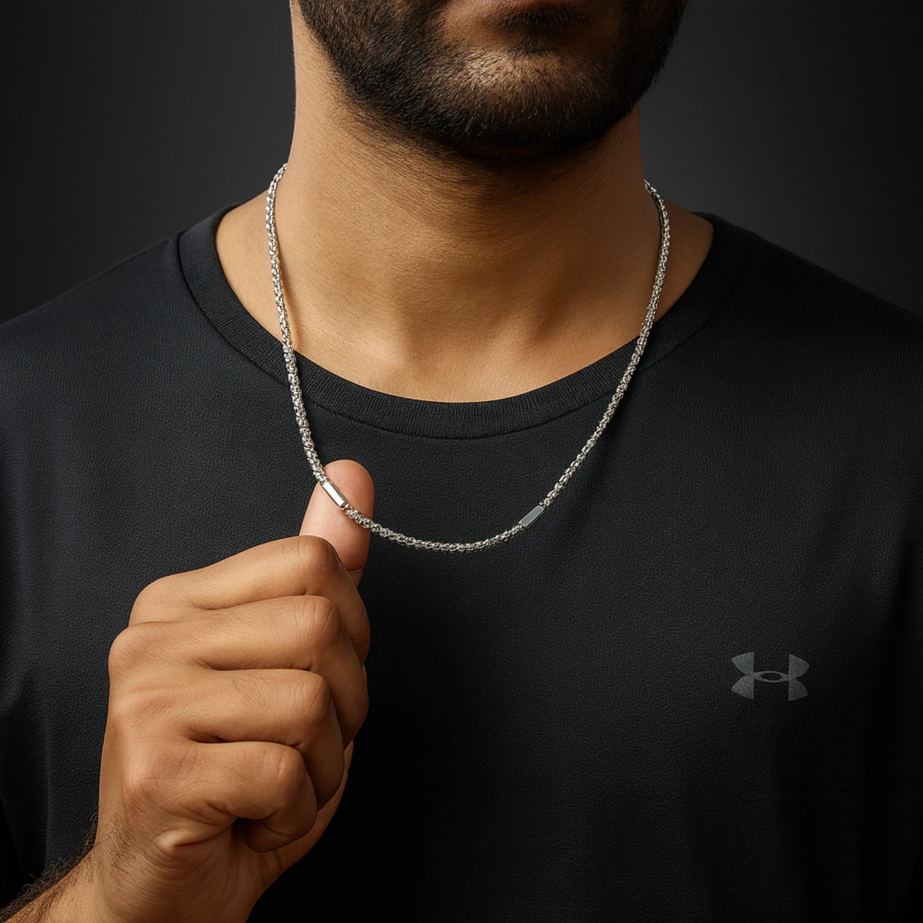 Man wearing a black Under Armour shirt with a silver necklace. First Dot Silver Ball Beaded Chain for Men