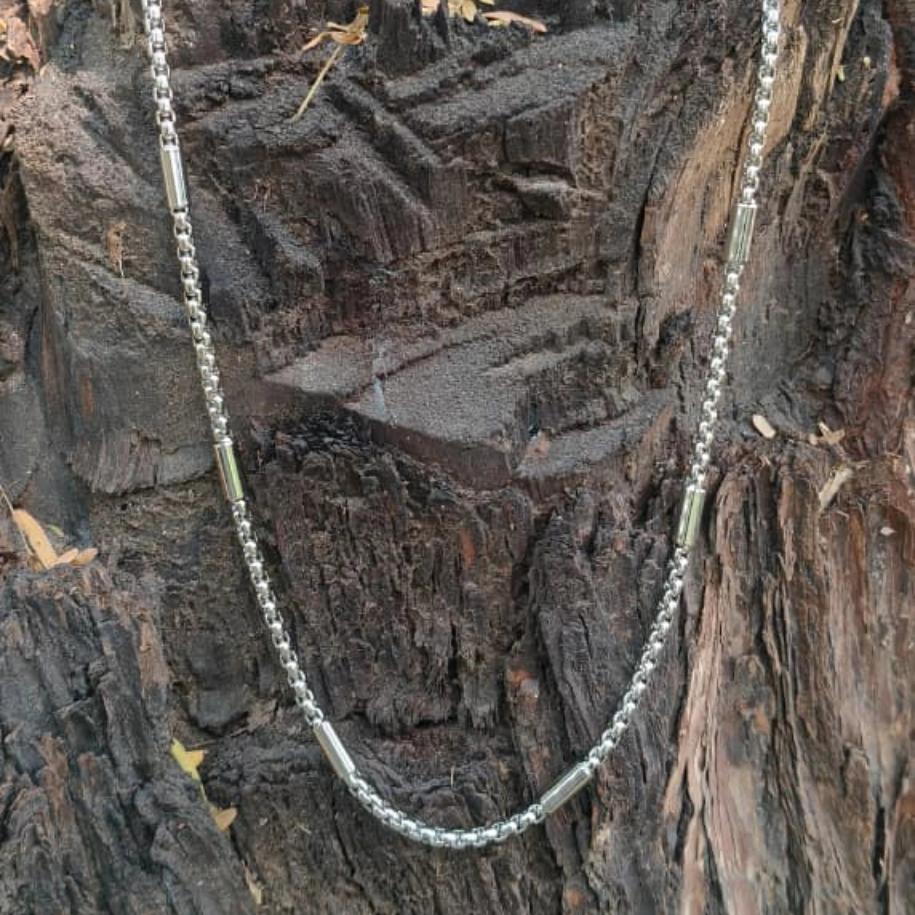 Silver chain necklace on a textured wooden background First Dot Silver Ball Beaded Chain for Men