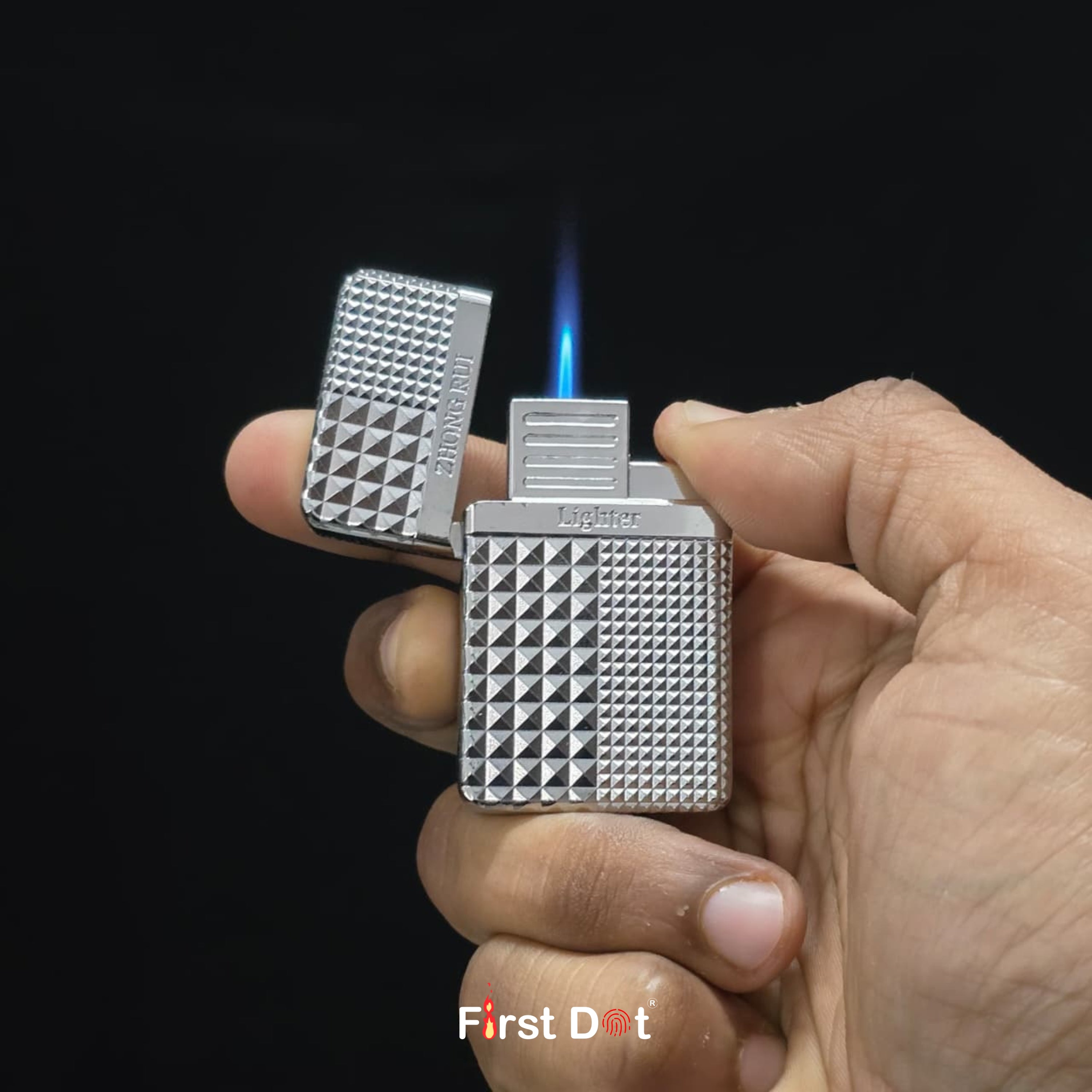 Hand holding a Diamond cut textured lighter with 'First Dot' branding against a black background
