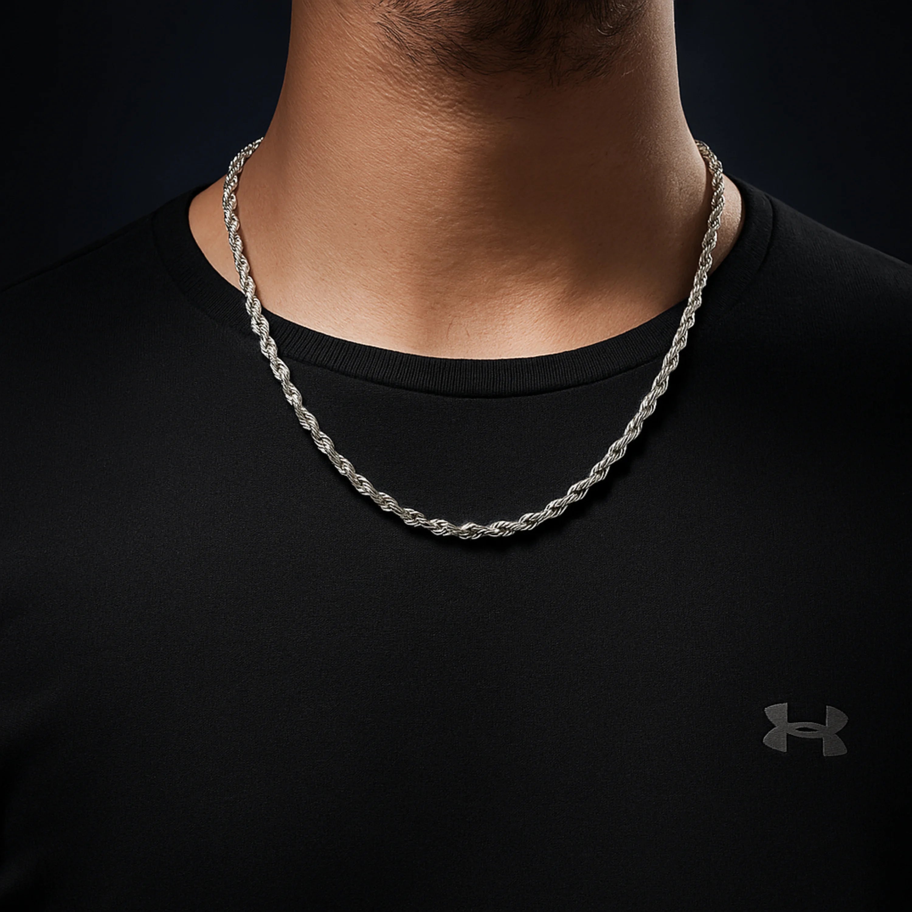 Silver chain necklace on a person wearing a black shirt with Under Armour  First dot Silver Rope Chain for Men – Classic Stylish Necklace logo.