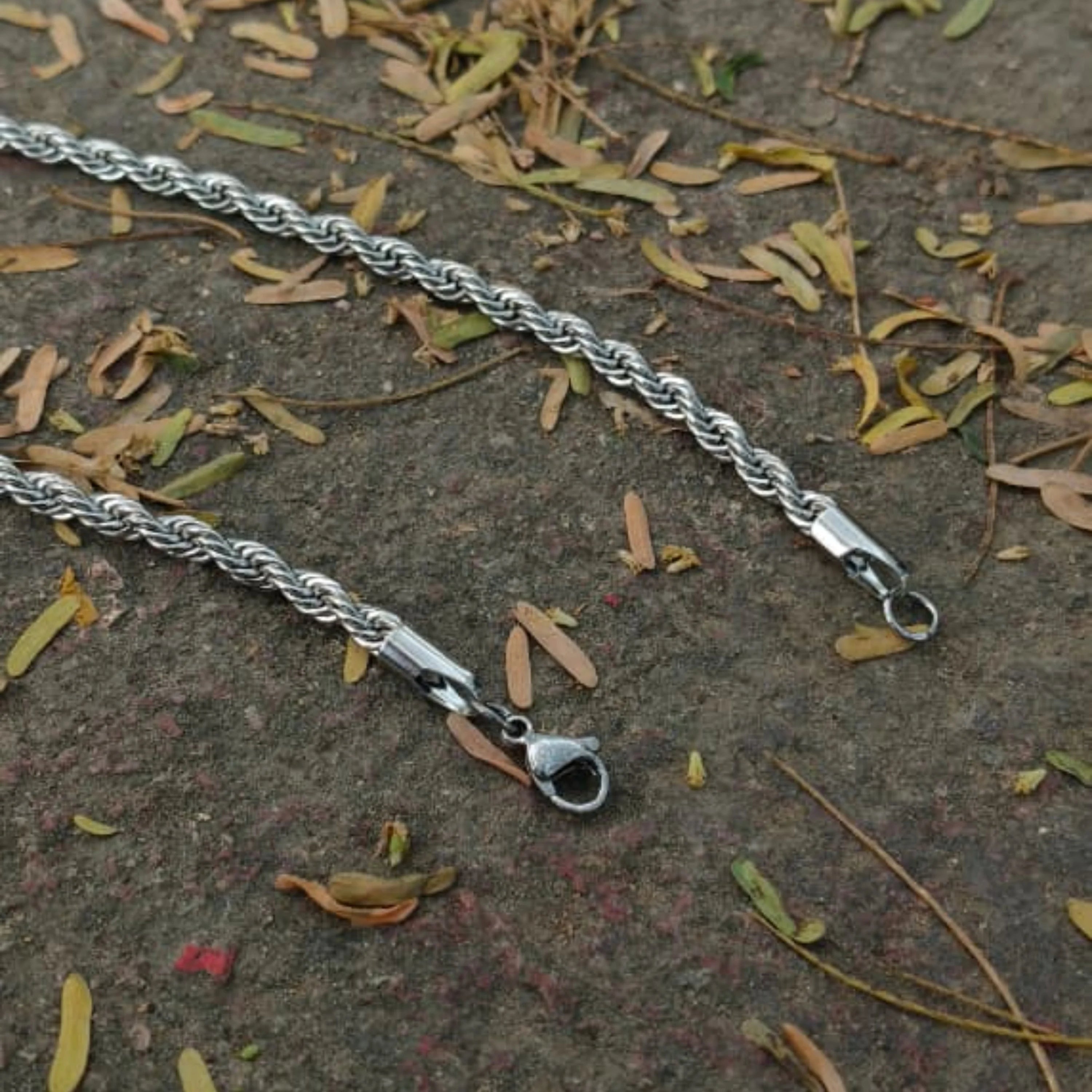 Silver rope chain bracelet on a textured surface with leaves  First dot Silver Rope Chain for Men – Classic Stylish Necklace
