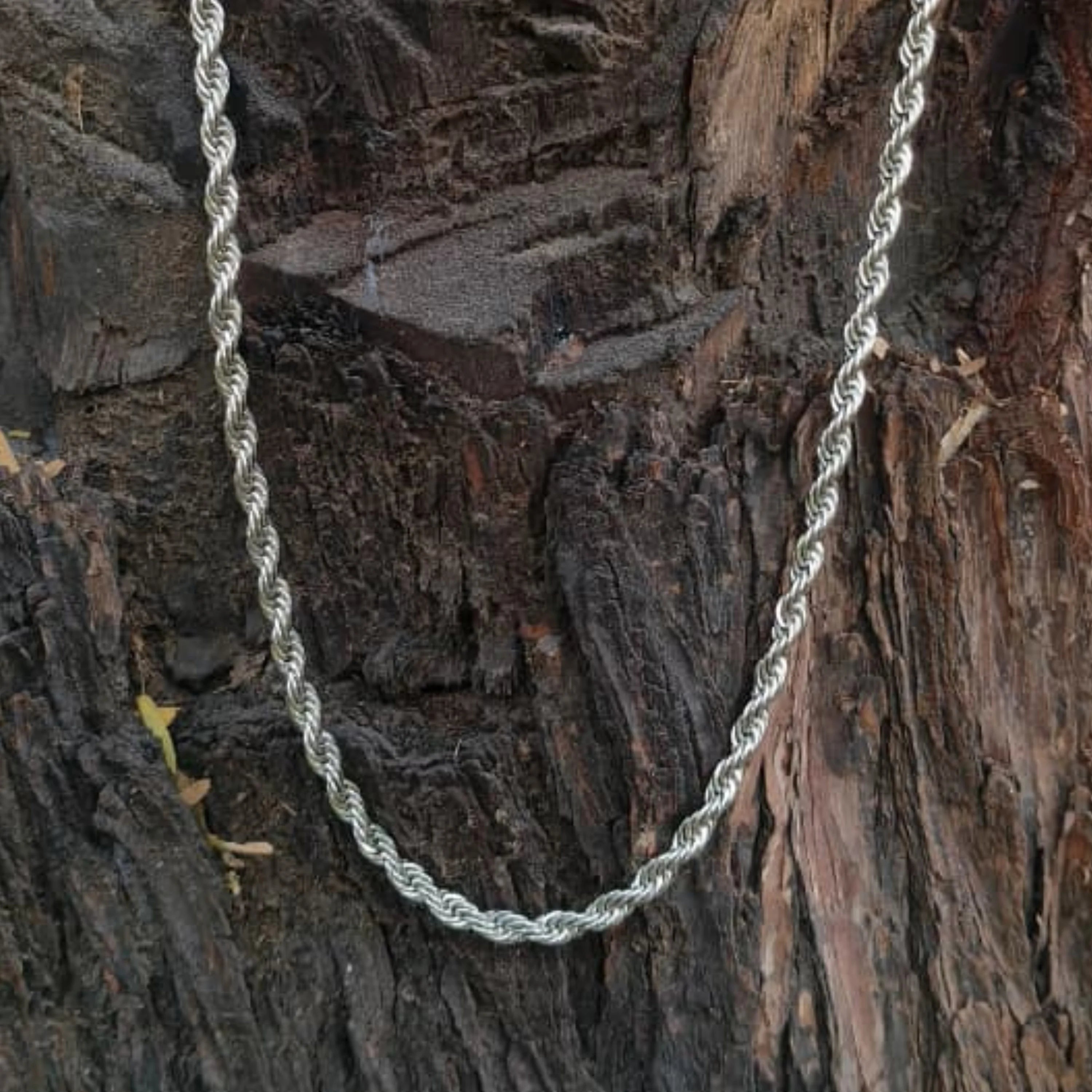 Silver rope chain on a textured wooden surface  First dot Silver Rope Chain for Men – Classic Stylish Necklace
