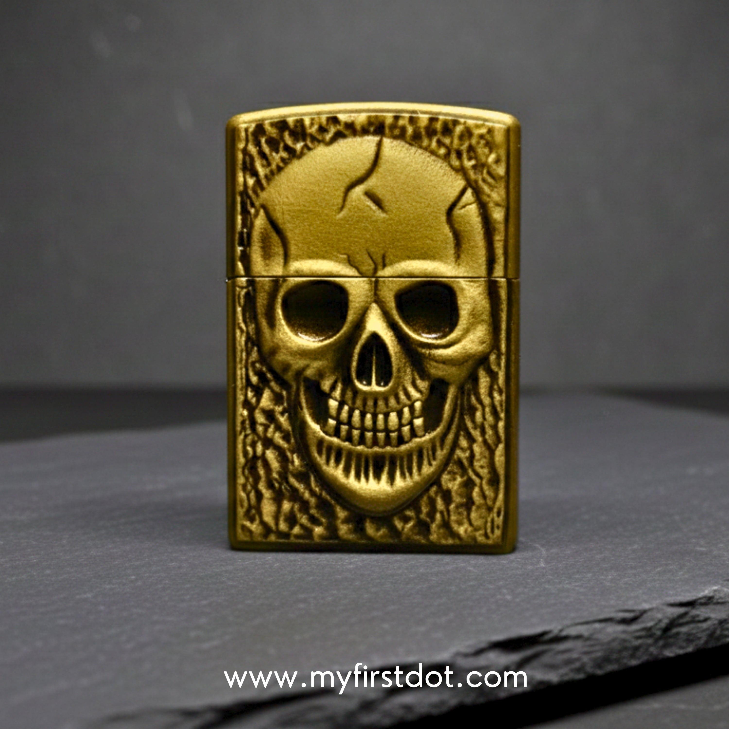 Gold skull-themed lighter on a dark gray background with 'www.myfirstdot.com' text.