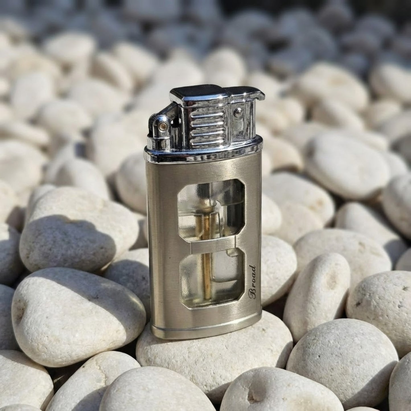 Metal lighter with transparent design on pebbles