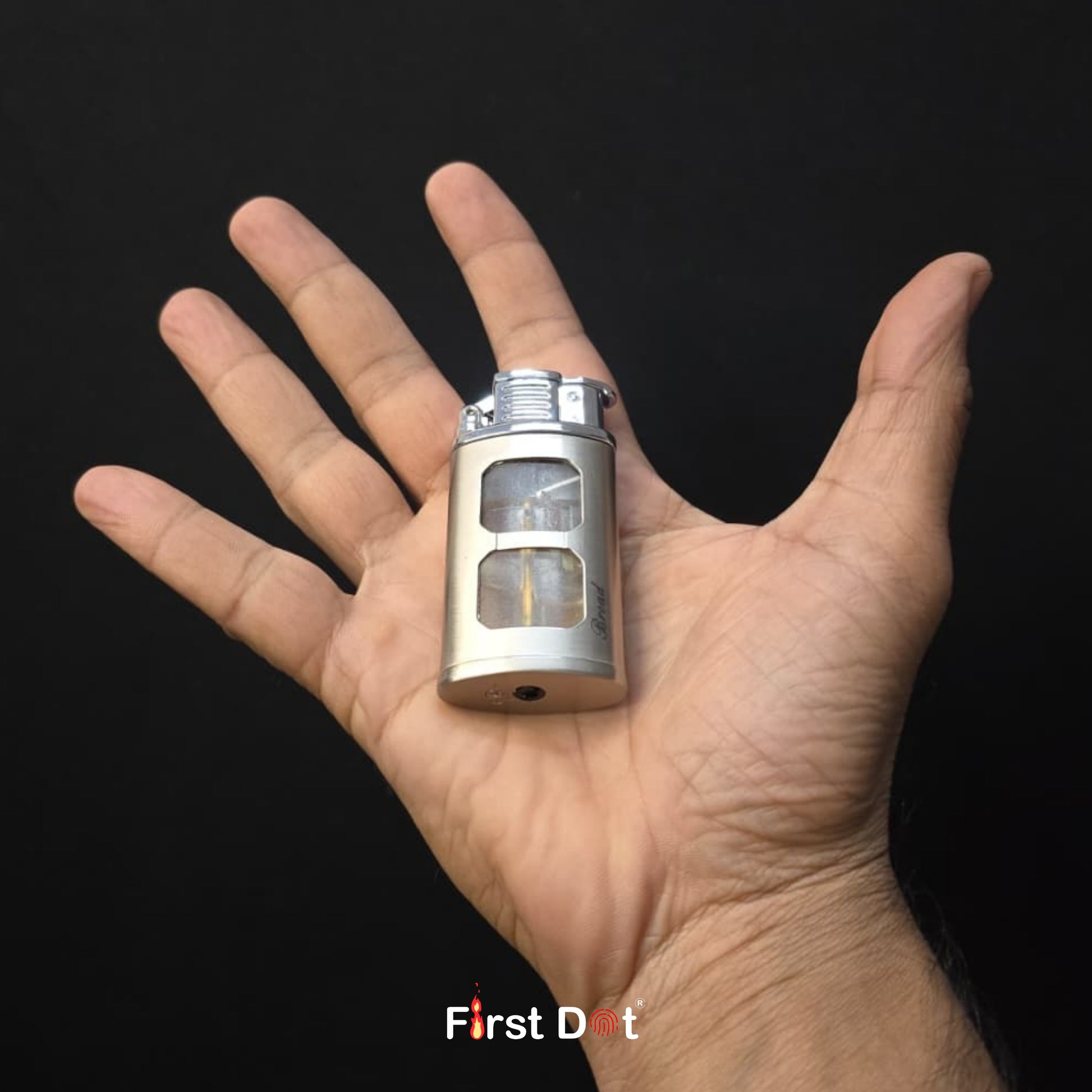 Small metallic device held in a hand against a black background with 'First Dot' branding.