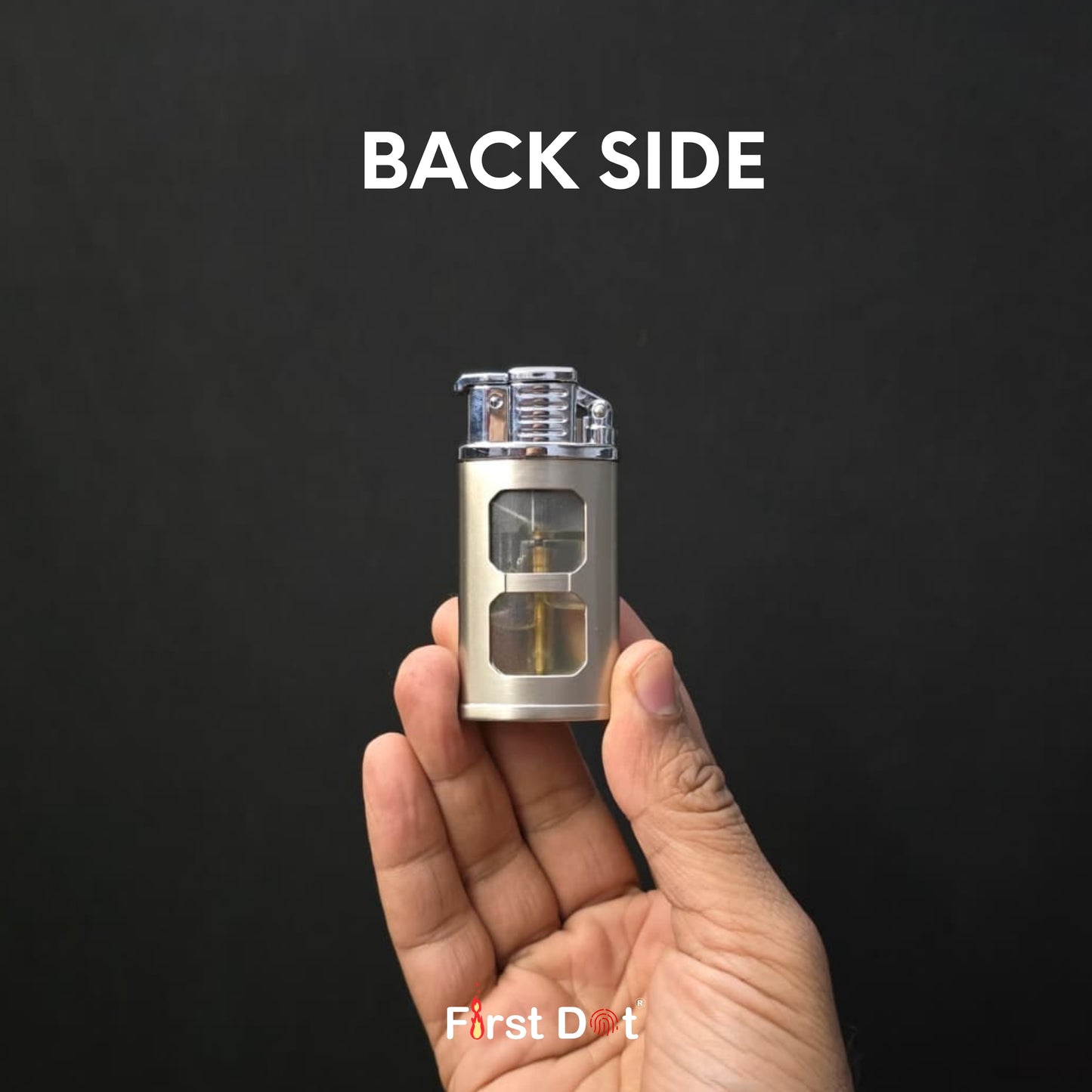 Hand holding a small metallic device labeled 'First Dot' with 'BACK SIDE' text on a black background.