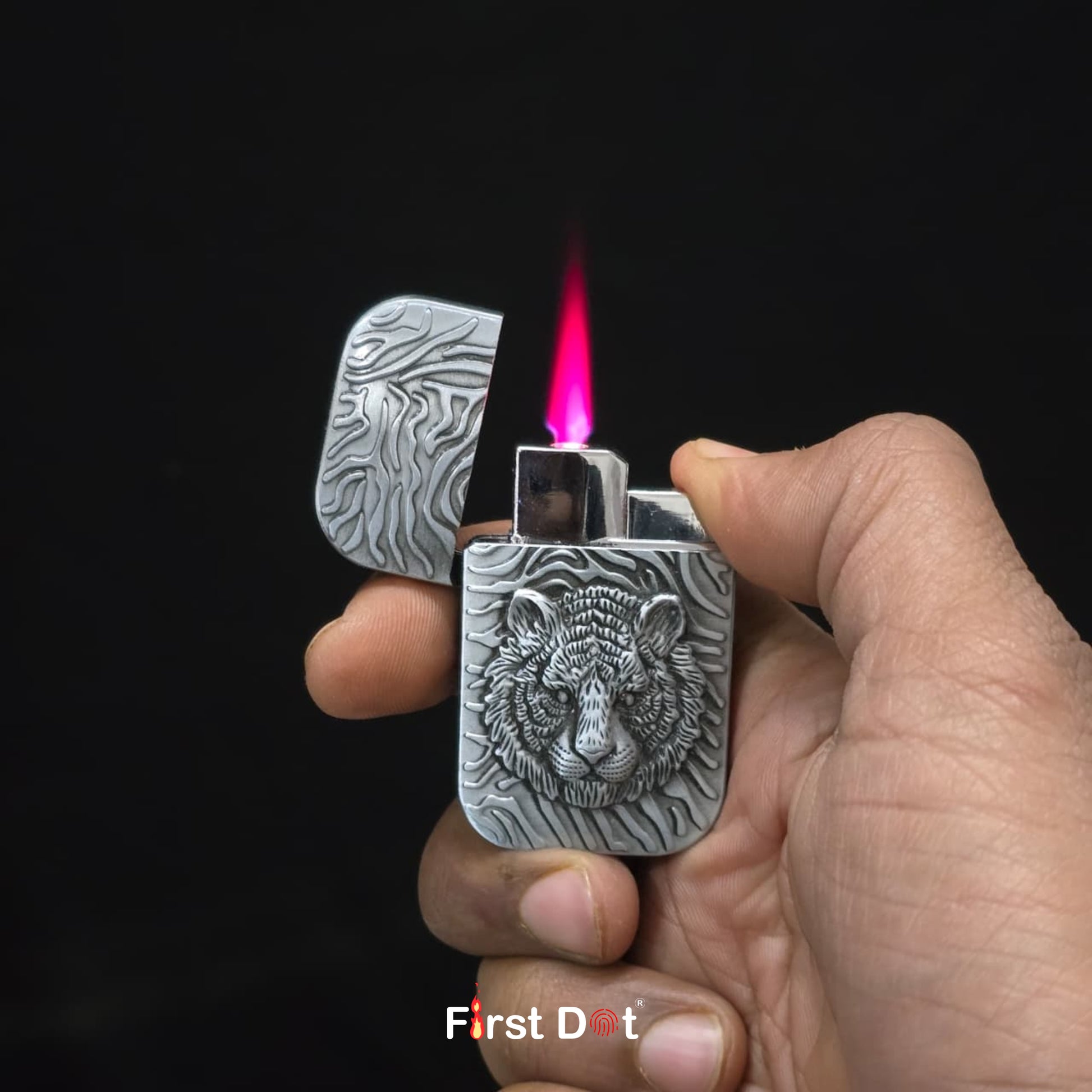 Hand holding a tiger lighter with a tiger design, lit against a black background.