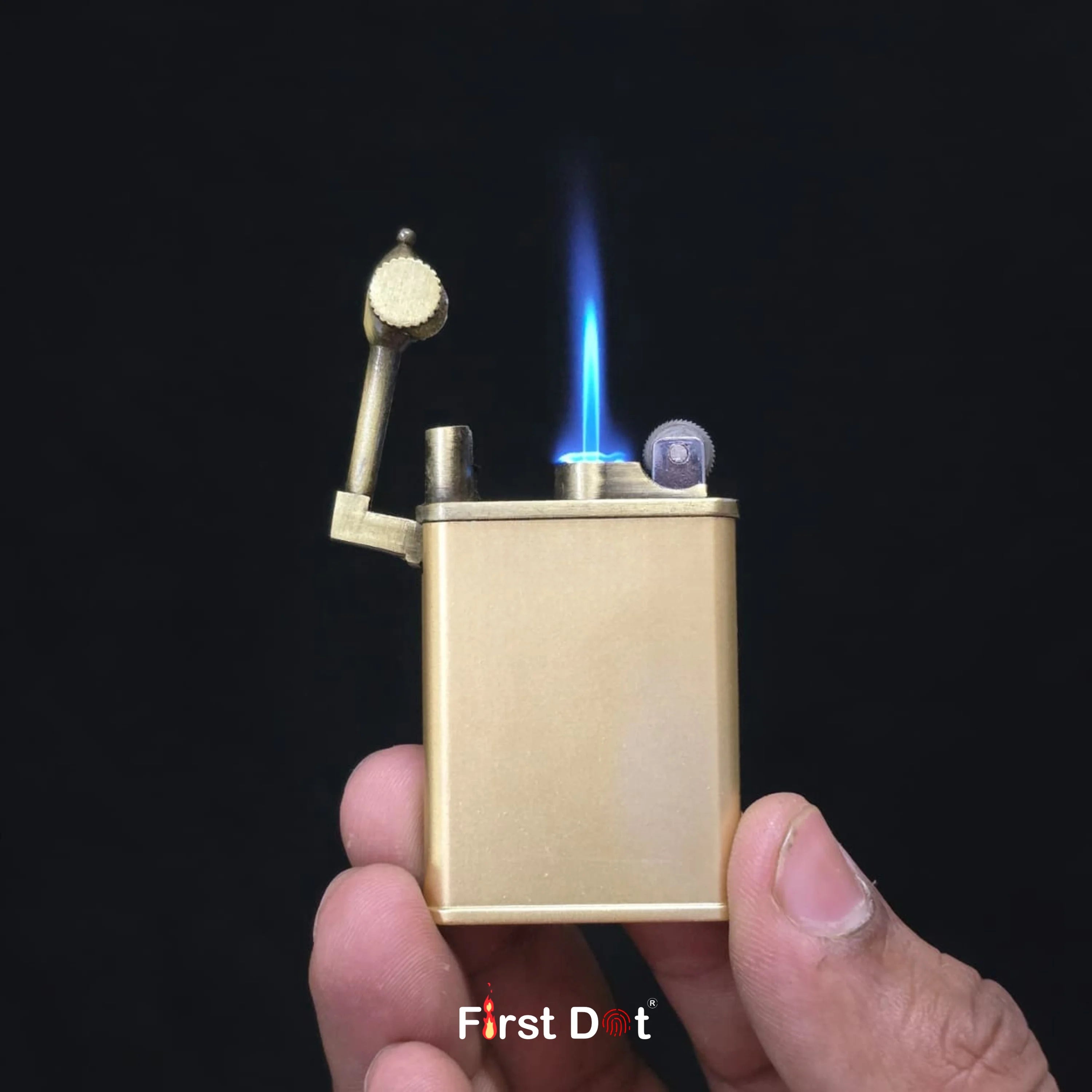 Gold lighter being used with a visible flame against a black background