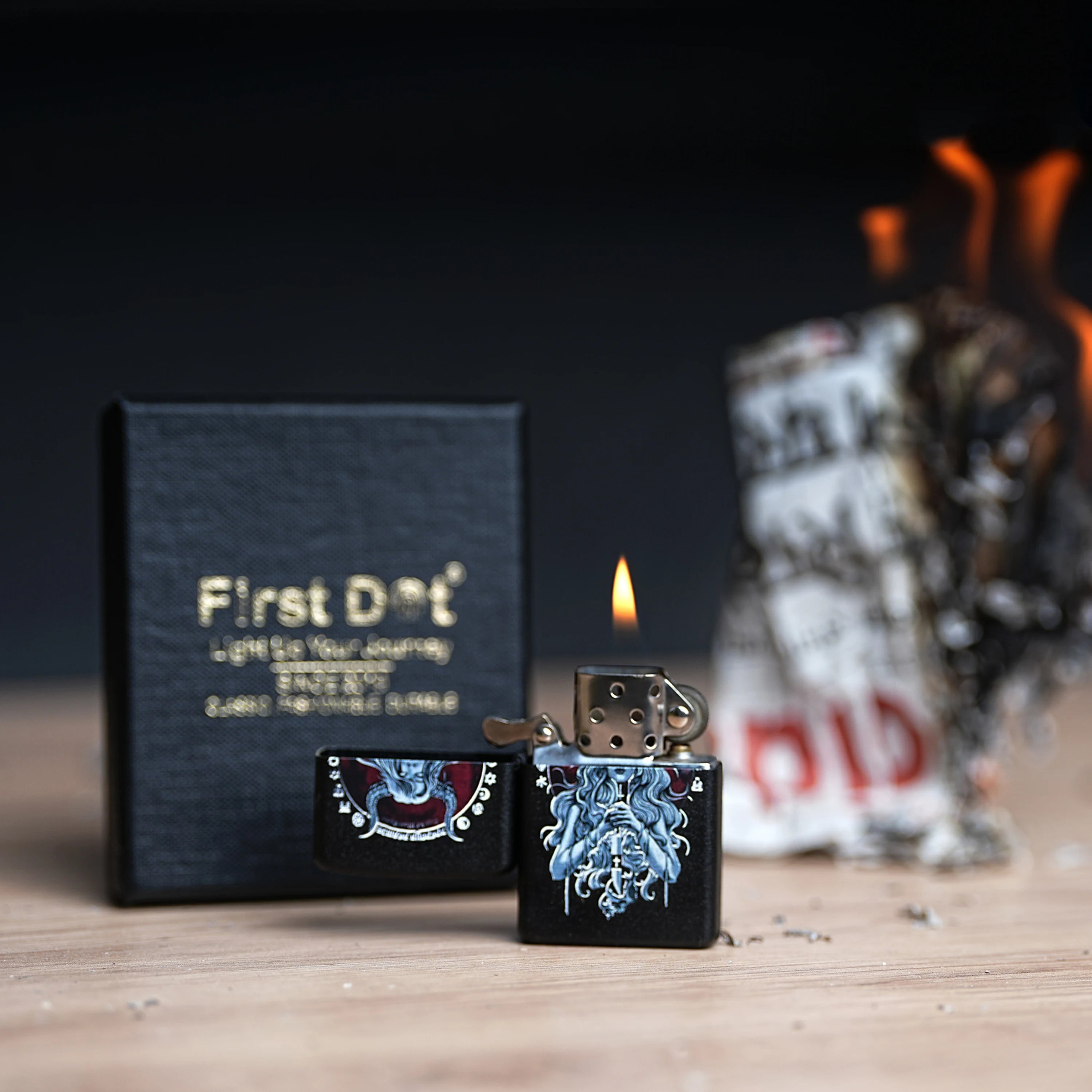 Lighter with decorative design and 'First Dot' packaging on a wooden surface. Witch Premium Refillable Cigarette Lighter