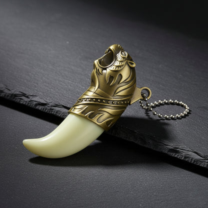 Decorative keychain with gold tribal design and white tooth-like structure on a dark surface Tiger's Roar Jet Flame Cigarette Lighter