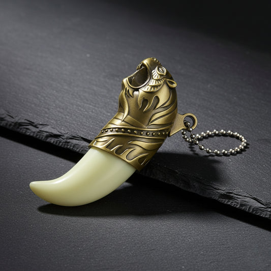 Decorative keychain with gold tribal design and white tooth-like structure on a dark surface Tiger's Roar Jet Flame Cigarette Lighter