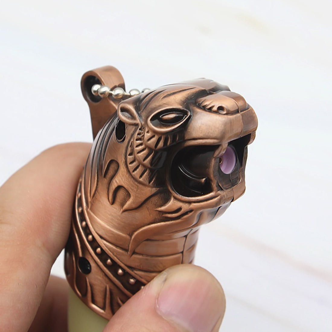 Bronze tiger-shaped lighter held by a hand against a white background Tiger's Roar Jet Flame Cigarette Lighter