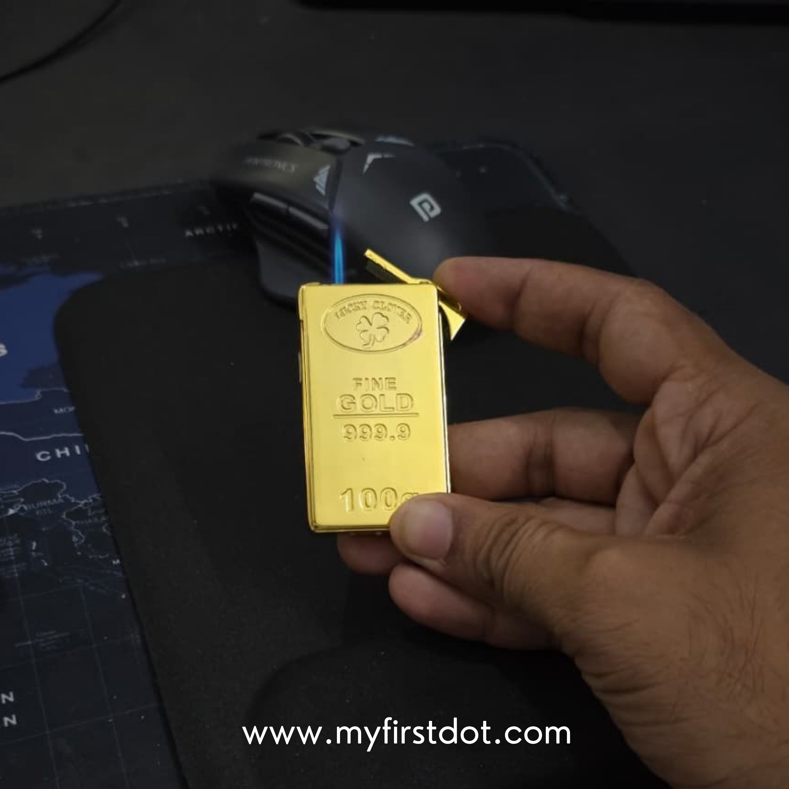 Hand holding a small gold bar with 'My First Dot' branding on a dark surface. first dot 100g Gold Bar Design Jet Flame Cigarette Lighter 