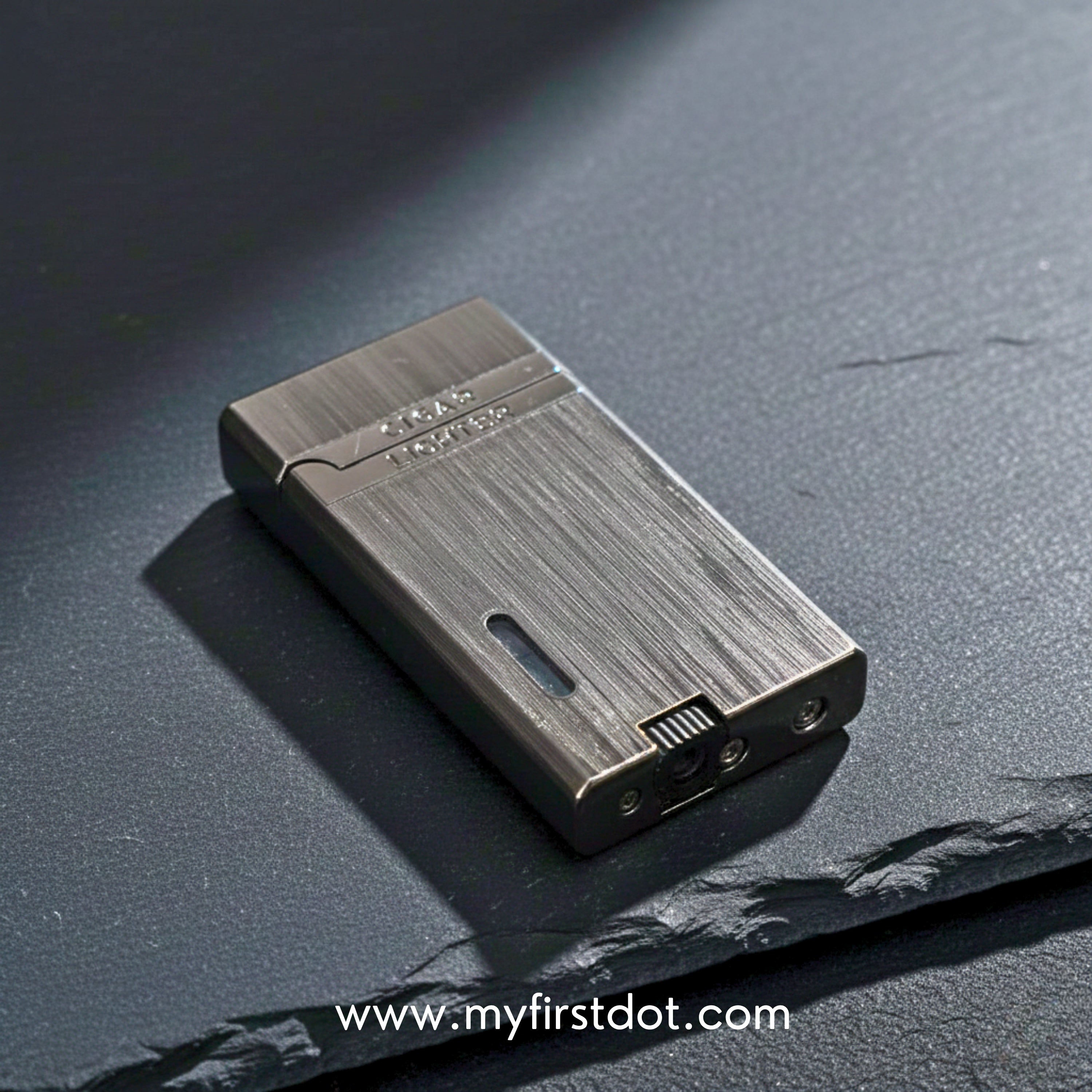 Metallic lighter on a dark textured surface with 'www.myfirstdot.com'  Monarch Double Flame Torch Lighter Brushed Greybranding.