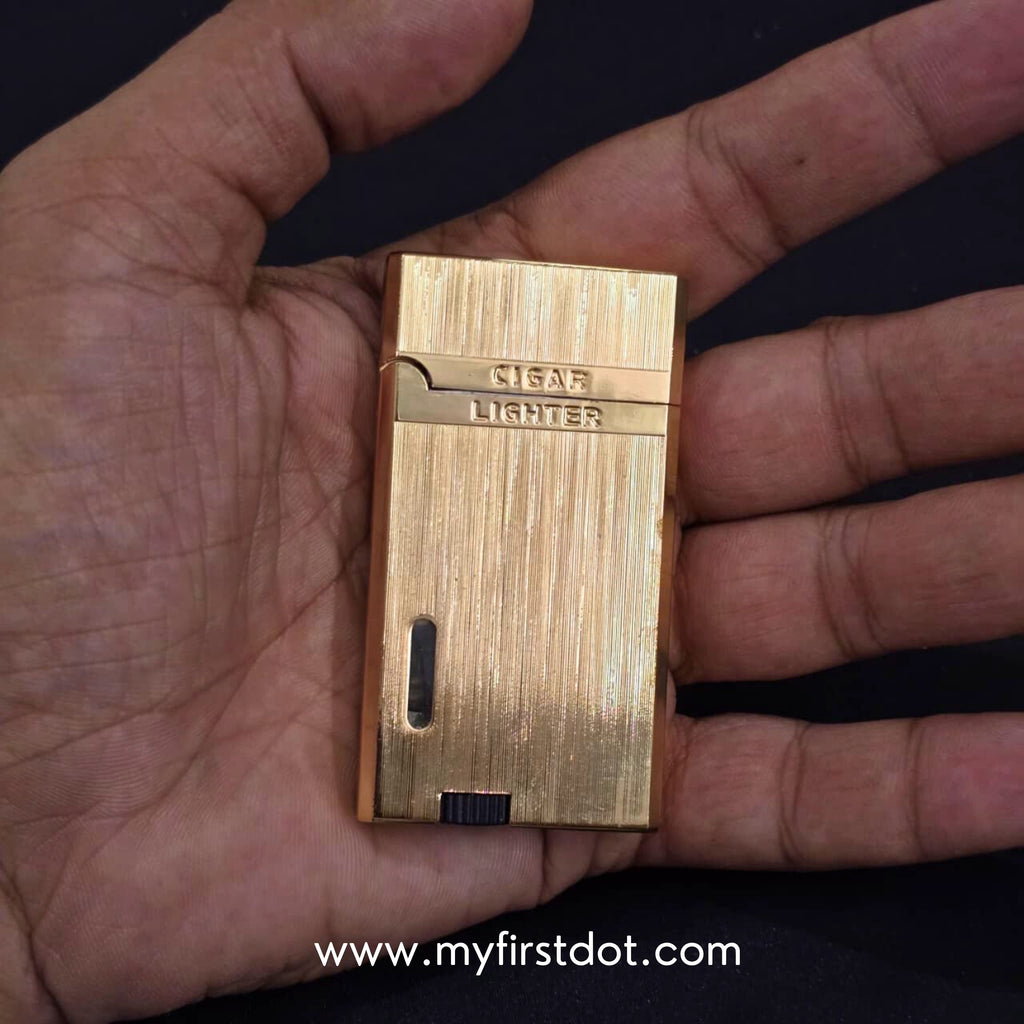 Gold lighter held in a hand with a visible brand watermark. Monarch Double Flame Torch Lighter Metallic Gold