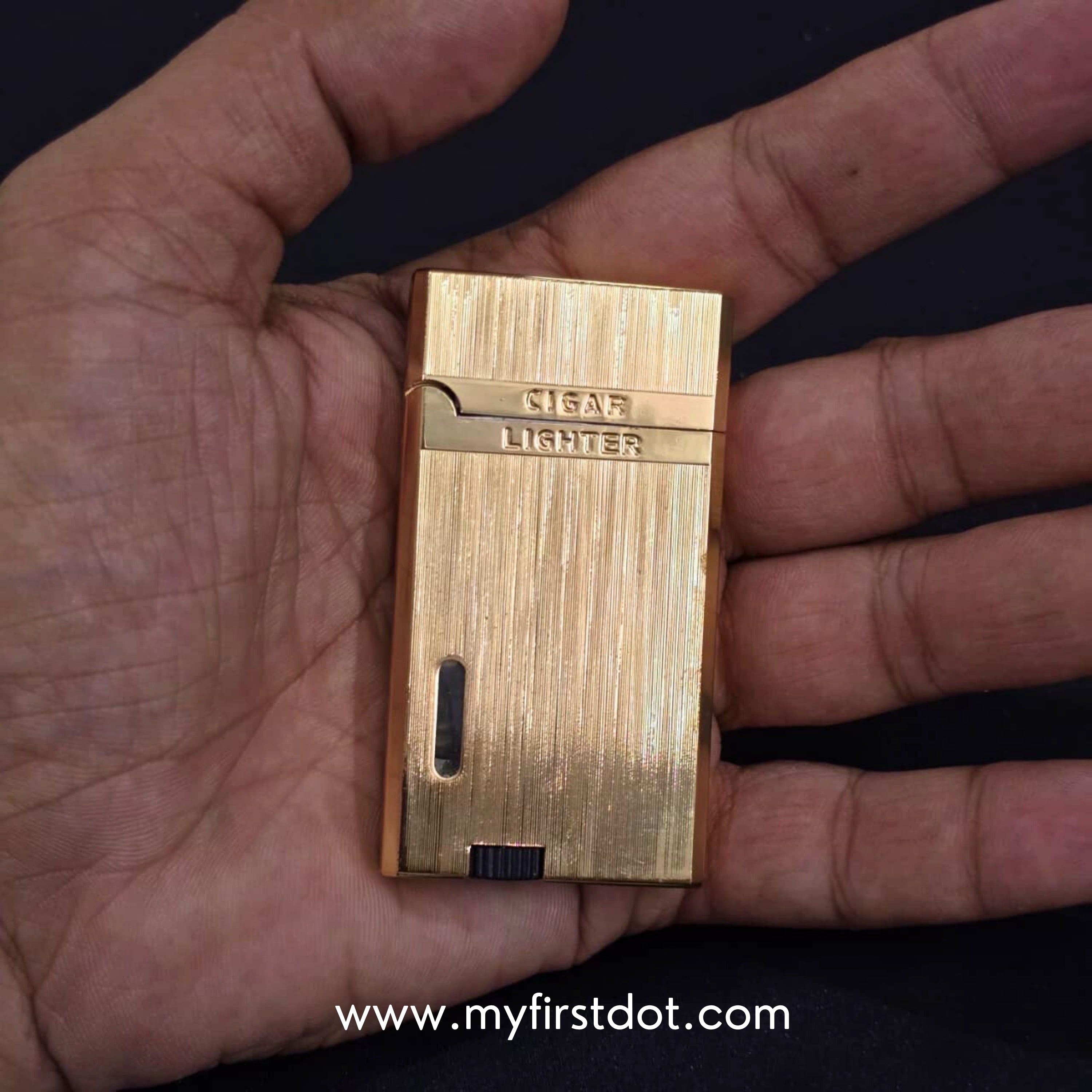 Gold lighter held in a hand with a visible brand watermark. Monarch Double Flame Torch Lighter Metallic Gold