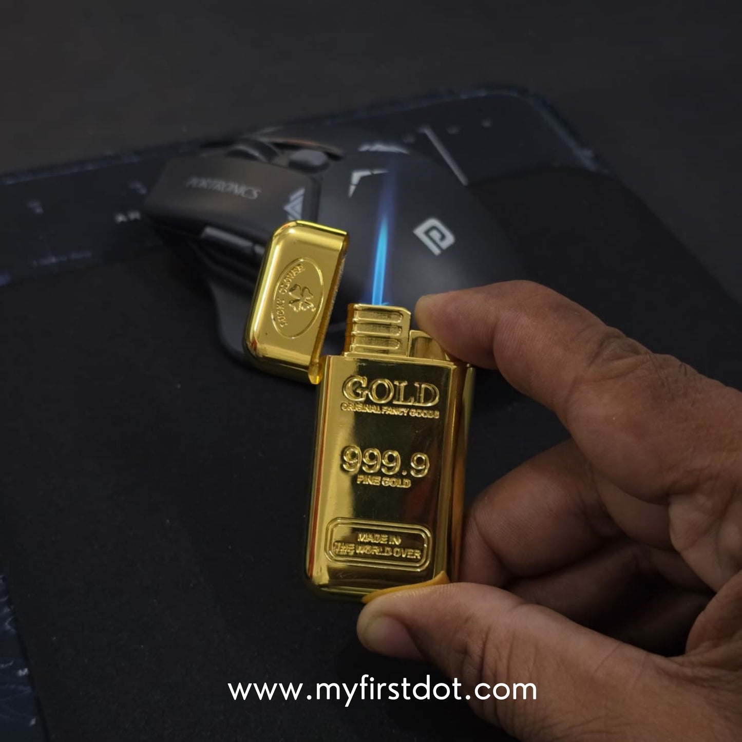 Gold bar lighter being used with a smartphone displaying the brand 'myfirstdot'. first dot Premium Gold Bar Jet Flame Lighter  999.9 Engraved Windproof Flame