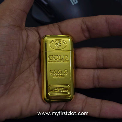 Gold bar held in a hand with a visible brand logo in the background first dot Premium Gold Bar Jet Flame Lighter  999.9 Engraved Windproof Flame