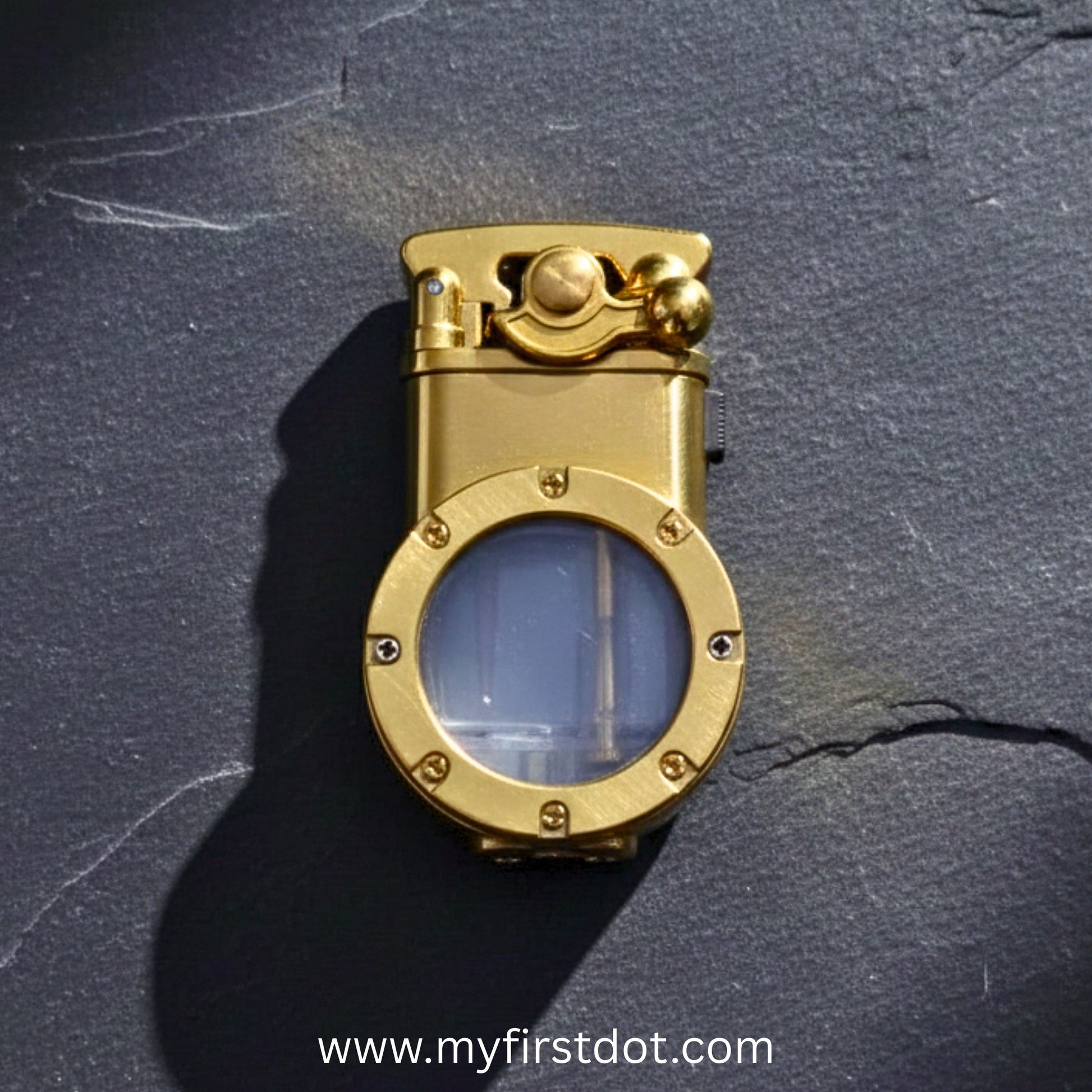 Gold pocket watch on a dark textured surface with 'www.myfirstdot.com' first dot Vintage Trench Retro Rocker Lighter | Dual Flame Lighter. 