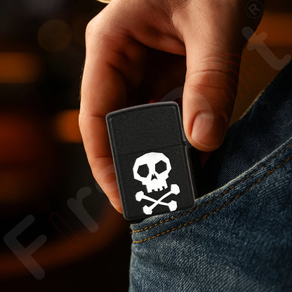 Hand holding a black lighter with a skull and crossbones design, against a blurred background. Death Note Skull Premium Refillable Cigarette Lighter First Dot
