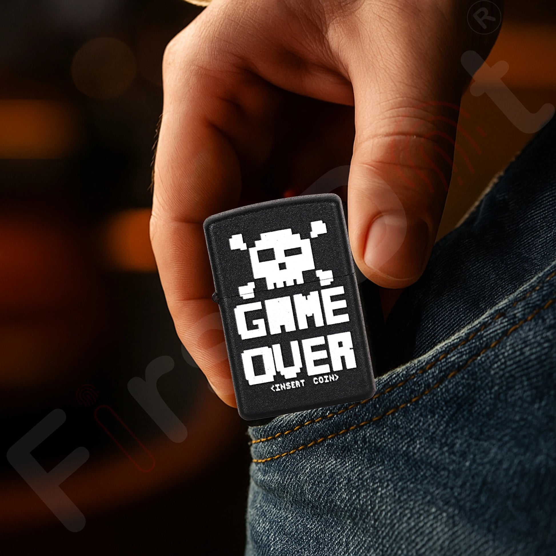 Hand holding a 'Game Over' patch with pixelated design against a blurred background Game Over Premium Refillable Cigarette Lighter first dot